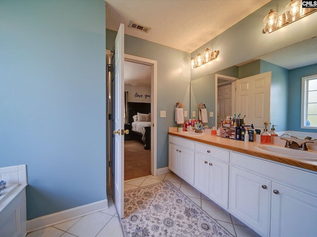 78 Southern Oak Dr, Camden, SC 29020 - bathroom with a textured ceiling, visible vents, tile patterned flooring, and a sink