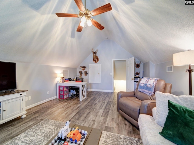 78 Southern Oak Dr, Camden, SC 29020 - living area with vaulted ceiling, a ceiling fan, wood finished floors, baseboards, and visible vents