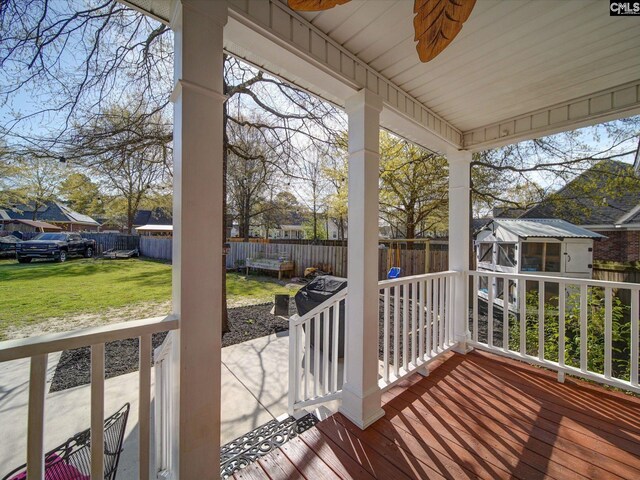 78 Southern Oak Dr, Camden, SC 29020 - wooden deck with a fenced backyard, a ceiling fan, an outdoor structure, and a yard