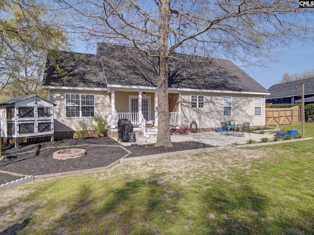 78 Southern Oak Dr, Camden, SC 29020 - back of house featuring fence, a yard, a patio area, a fire pit, and roof with shingles