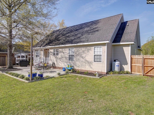78 Southern Oak Dr, Camden, SC 29020 - back of property featuring a patio area, a lawn, fence, and roof with shingles