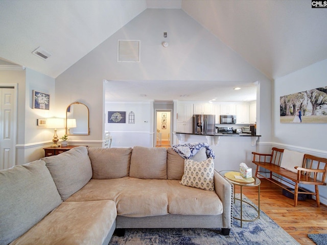 78 Southern Oak Dr, Camden, SC 29020 - living area featuring high vaulted ceiling, ornamental molding, visible vents, and light wood-style flooring