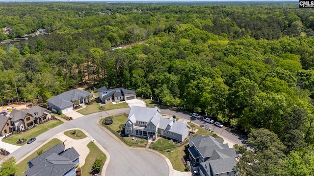 drone / aerial view with a forest view and a residential view