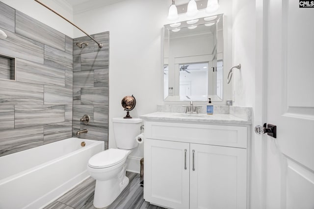 full bath featuring crown molding, vanity,  shower combination, ceiling fan, and toilet