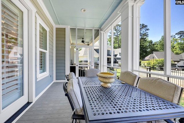 sunroom featuring a ceiling fan
