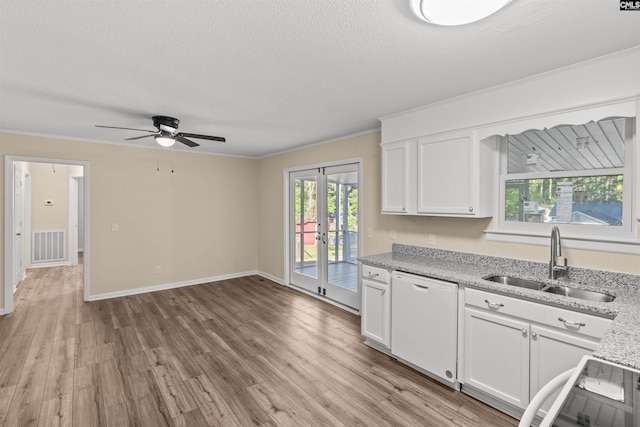 1015 Mandel Dr, Columbia, SC 29210 - kitchen with dishwasher, light wood finished floors, white cabinetry, and a sink