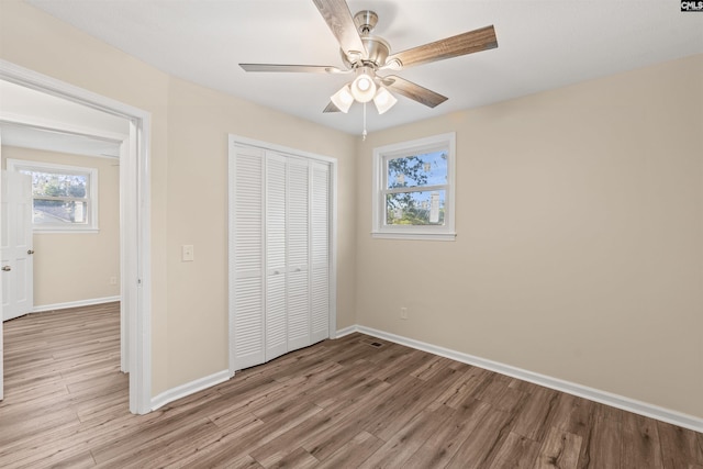 1015 Mandel Dr, Columbia, SC 29210 - unfurnished bedroom featuring a closet, light wood finished floors, baseboards, and a ceiling fan