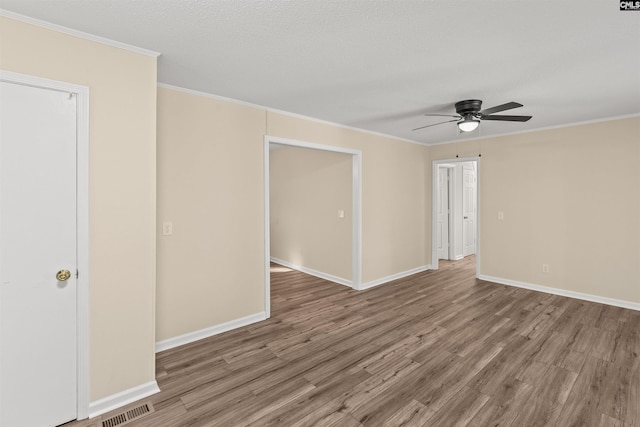 1015 Mandel Dr, Columbia, SC 29210 - unfurnished room with wood finished floors, visible vents, ornamental molding, baseboards, and ceiling fan