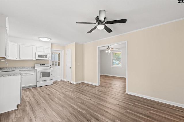 1015 Mandel Dr, Columbia, SC 29210 - kitchen with a ceiling fan, a sink, white appliances, light wood-type flooring, and white cabinetry