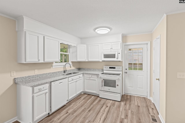 1015 Mandel Dr, Columbia, SC 29210 - kitchen with a sink, white appliances, light wood-style flooring, white cabinetry, and visible vents