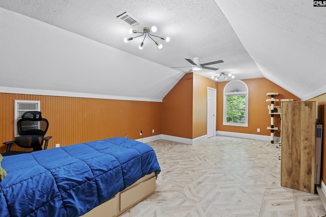 bedroom with baseboards, vaulted ceiling, visible vents, and a textured ceiling
