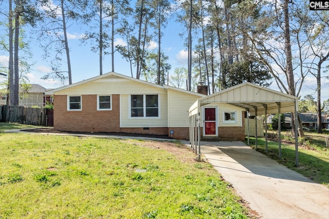 ranch-style home with concrete driveway, a chimney, a carport, fence, and a front yard