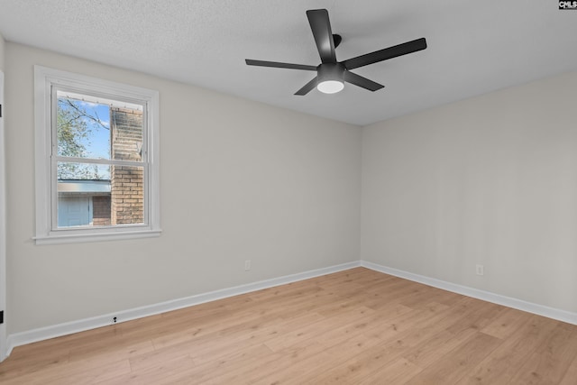 unfurnished room featuring light wood finished floors, baseboards, and a ceiling fan