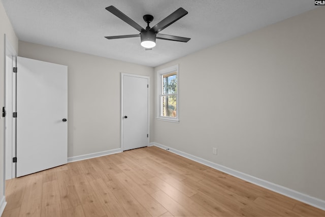 unfurnished bedroom with baseboards, a ceiling fan, and light wood-type flooring