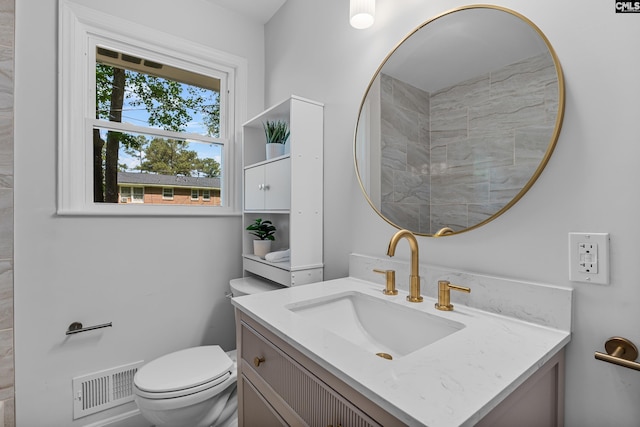 bathroom with visible vents, toilet, and vanity