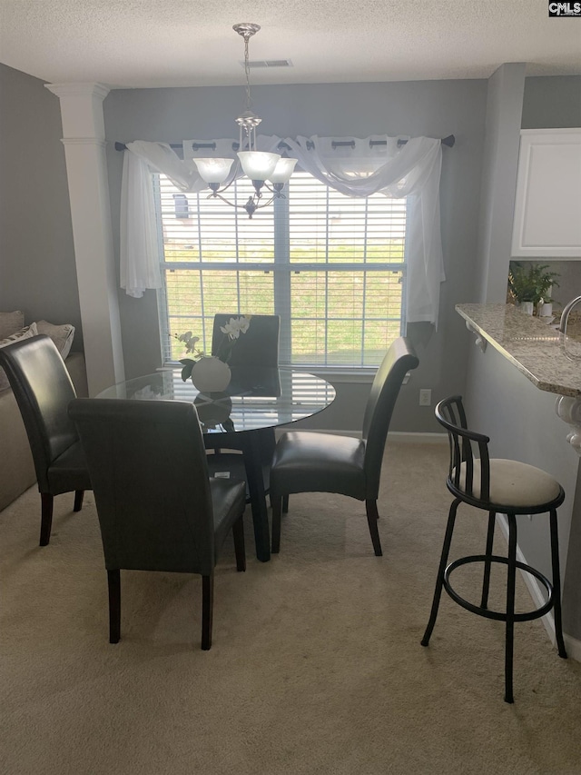 dining area featuring a chandelier, a wealth of natural light, and light carpet