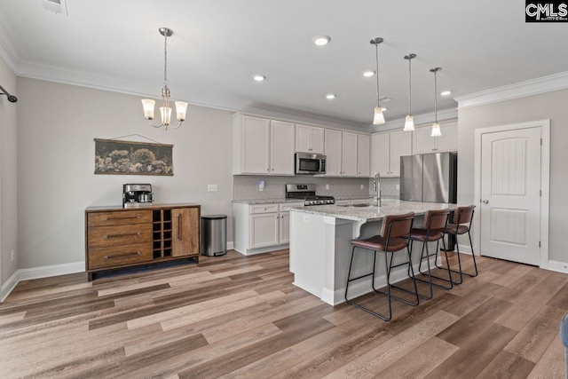 kitchen with recessed lighting, white cabinetry, appliances with stainless steel finishes, and crown molding