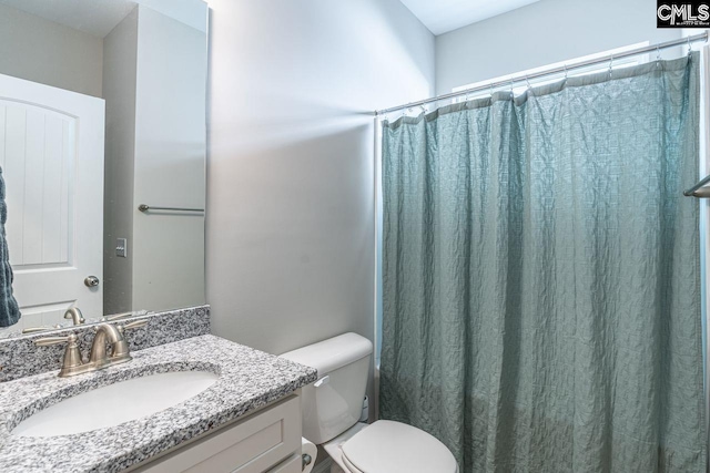 bathroom with a shower with shower curtain, toilet, and vanity