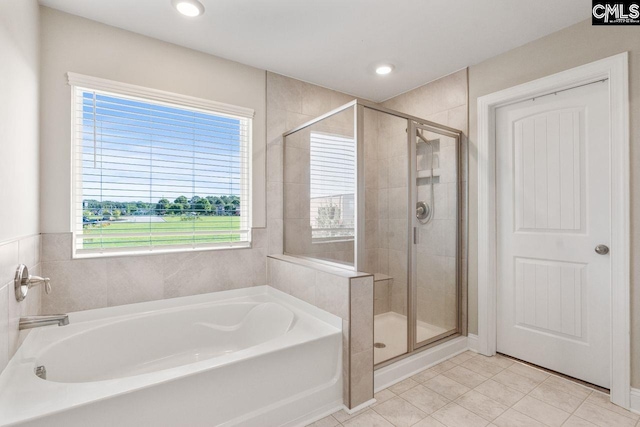 full bath featuring recessed lighting, a shower stall, a garden tub, and tile patterned floors