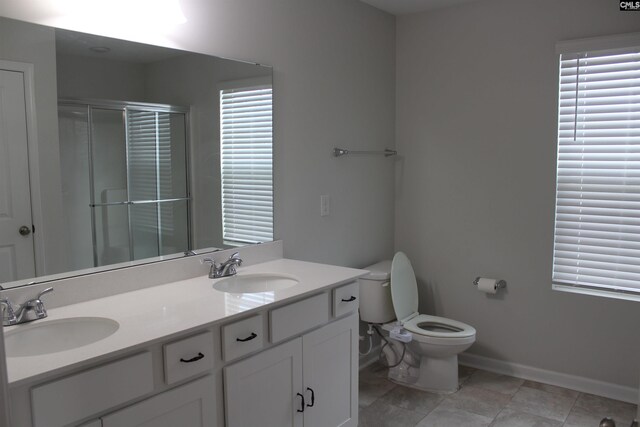 518 Cricket Chirp Ln, Elgin, SC 29045 - full bathroom featuring a stall shower, baseboards, double vanity, and toilet