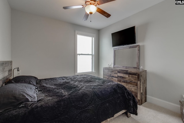 carpeted bedroom featuring baseboards and ceiling fan