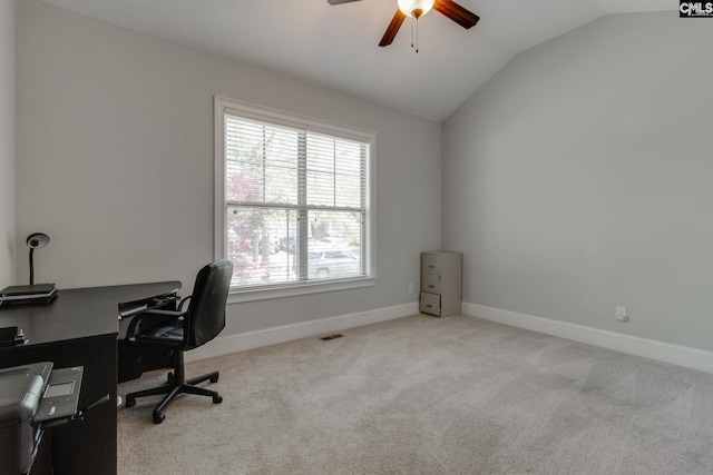 carpeted office with visible vents, vaulted ceiling, baseboards, and ceiling fan
