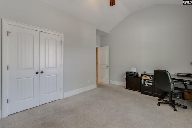 carpeted home office with vaulted ceiling and baseboards