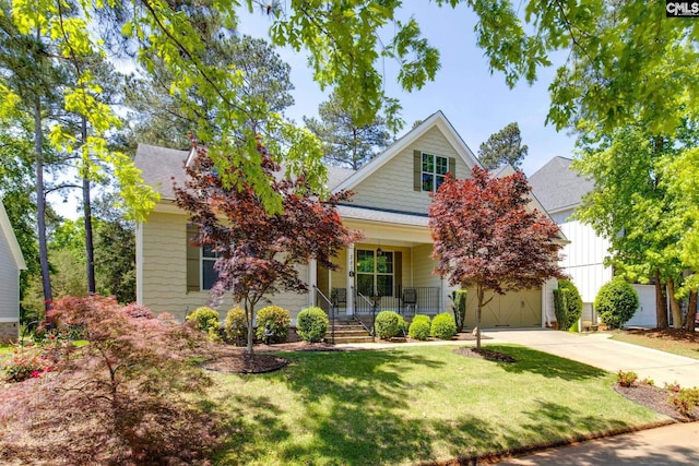 view of front of house with driveway, covered porch, and roof with shingles