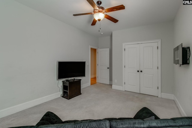 interior space featuring baseboards, carpet flooring, and ceiling fan