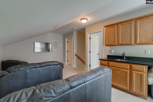 living room with light carpet, lofted ceiling, visible vents, and baseboards