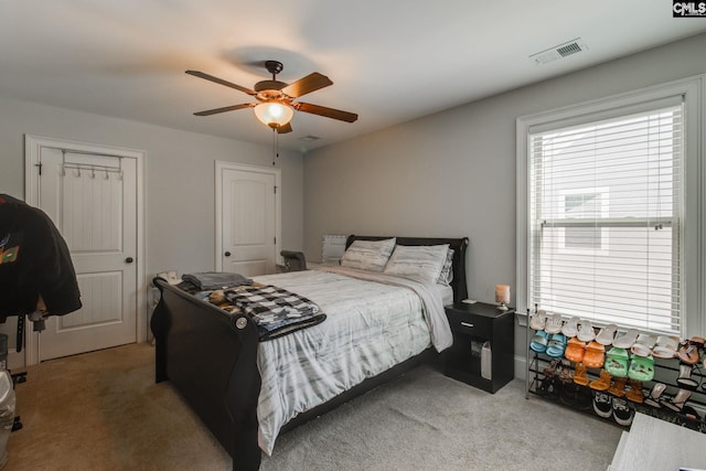 bedroom with a ceiling fan, carpet flooring, and visible vents