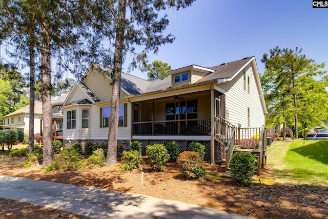 bungalow-style home featuring stairway, a front yard, and ceiling fan