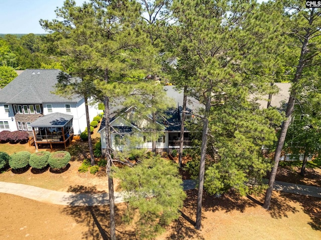 view of front facade featuring a deck and a shingled roof
