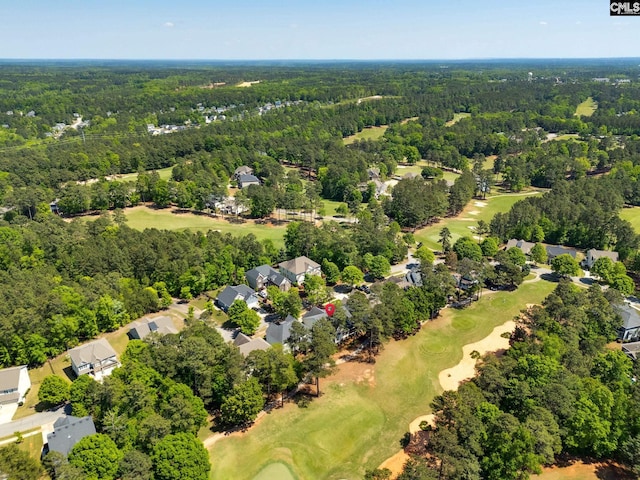 drone / aerial view featuring a forest view, a residential view, and view of golf course