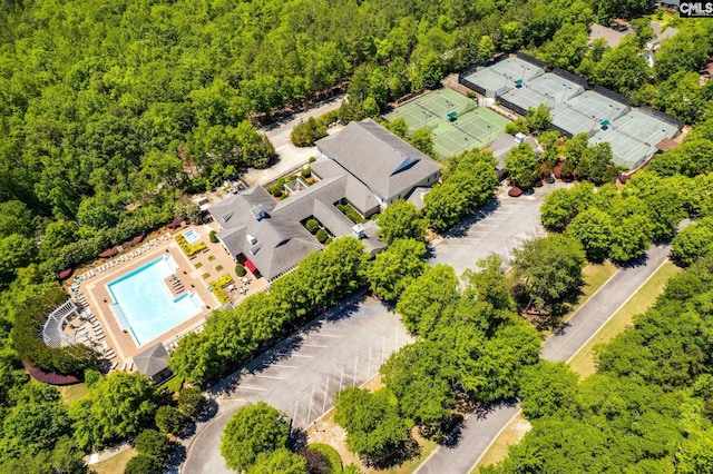 drone / aerial view featuring a forest view