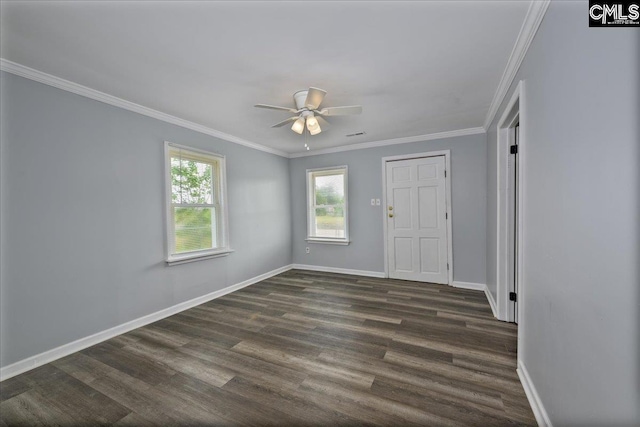 spare room with dark wood finished floors, baseboards, a ceiling fan, and crown molding