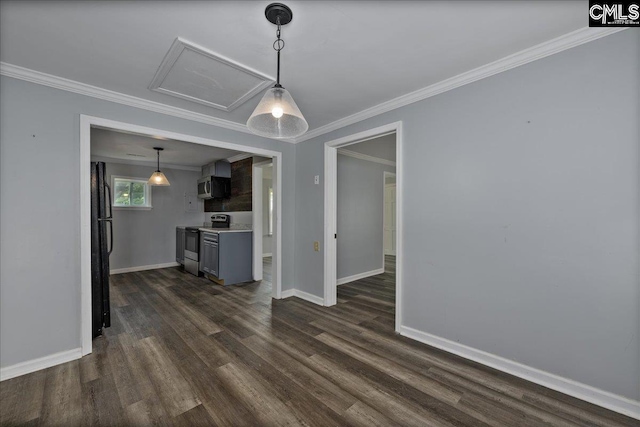 unfurnished living room featuring attic access, crown molding, dark wood-style flooring, and baseboards