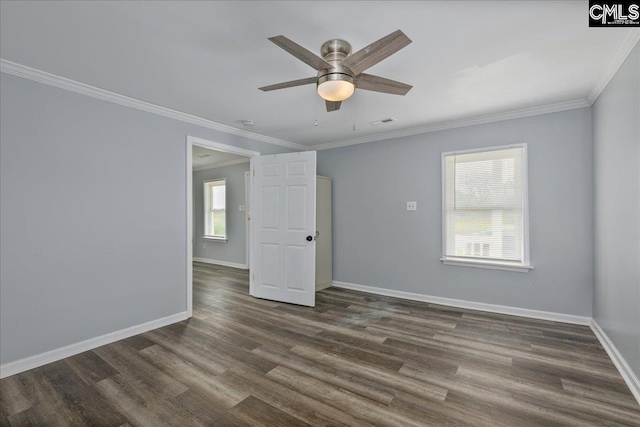 spare room with dark wood finished floors, baseboards, a ceiling fan, and crown molding