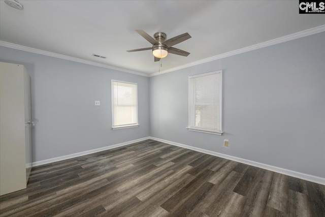 empty room with baseboards, ornamental molding, ceiling fan, dark wood-style floors, and visible vents