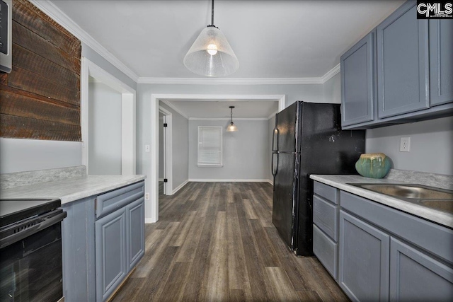 kitchen featuring crown molding, dark wood-style flooring, baseboards, and light countertops