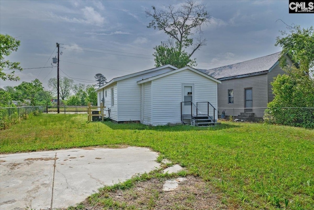back of property with fence and a yard