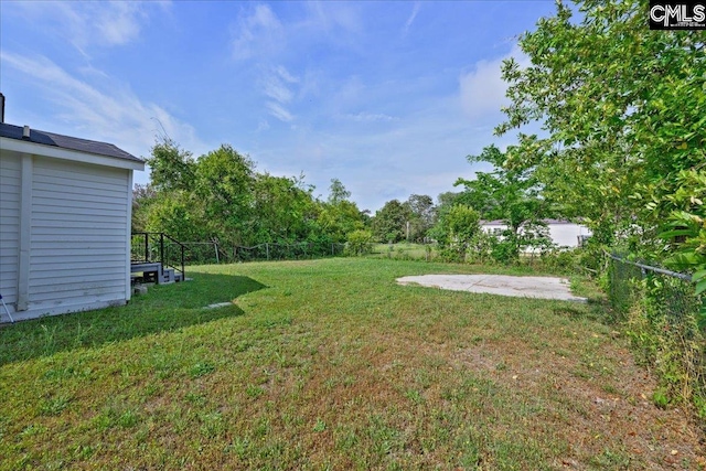 view of yard featuring a patio and fence