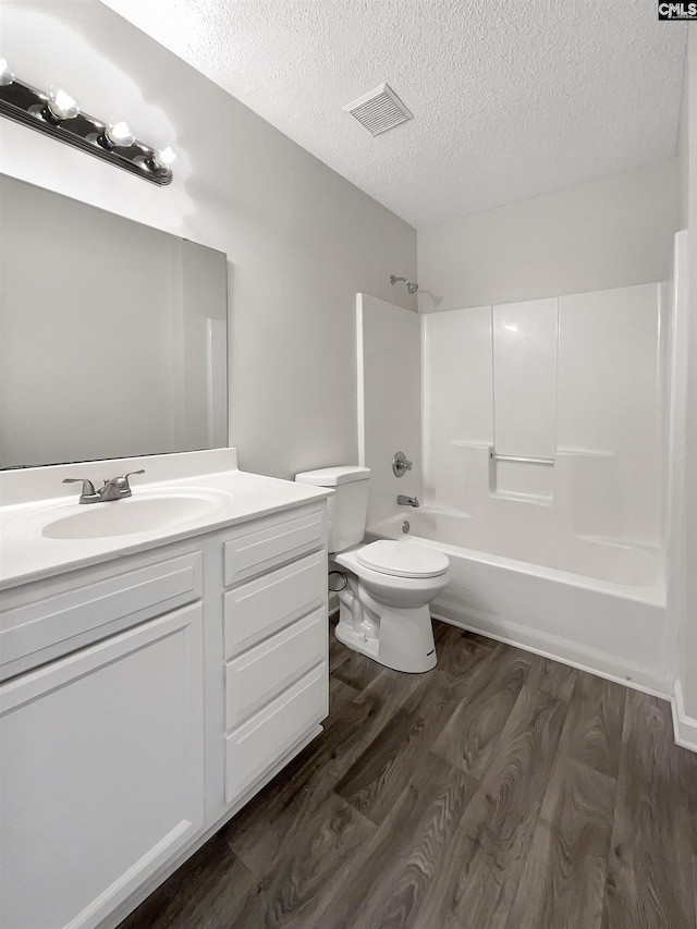 14 Long Glen Ct, Columbia, SC 29229 - bathroom featuring shower / bathing tub combination, a textured ceiling, wood finished floors, and visible vents