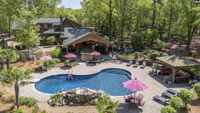 outdoor pool featuring a gazebo and a patio