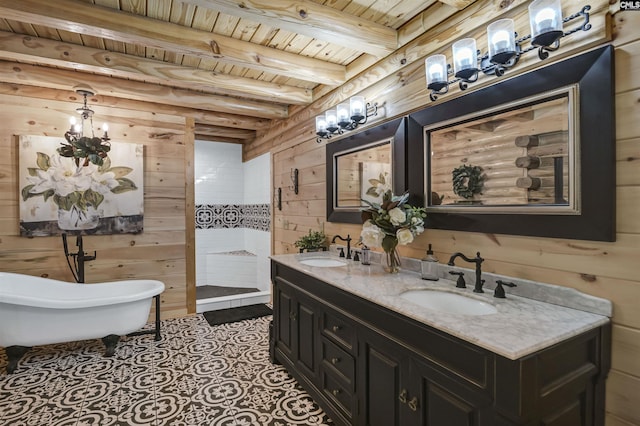 bathroom featuring a freestanding tub, wooden walls, wooden ceiling, and a sink