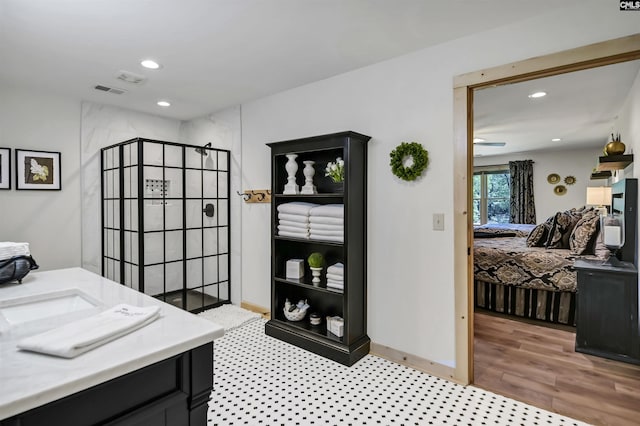 office space with a ceiling fan, light wood-style flooring, a sink, and recessed lighting