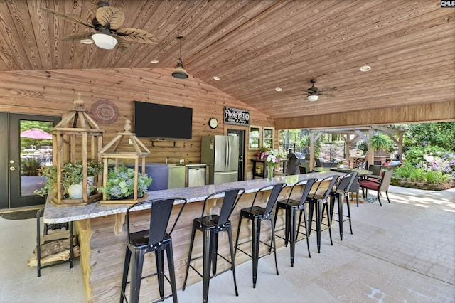 view of patio / terrace with outdoor dry bar and a ceiling fan
