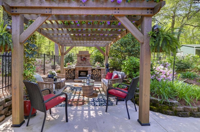 view of patio / terrace featuring fence, a pergola, and an outdoor living space with a fireplace