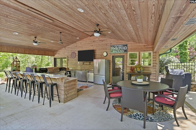 view of patio / terrace with fence, outdoor wet bar, a ceiling fan, and area for grilling