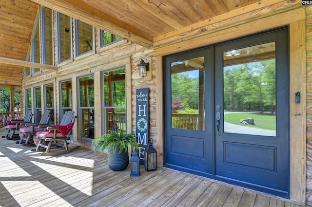 sunroom / solarium featuring french doors